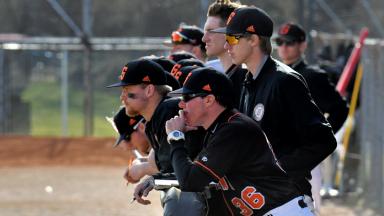 Georgetown College Baseball Team looks on from dugout.